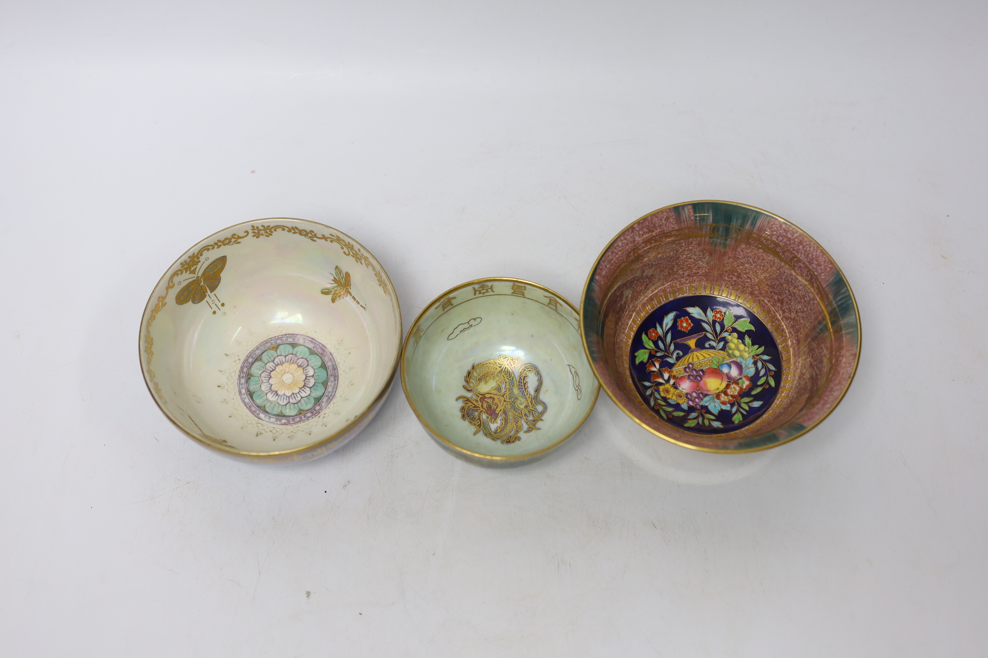A small Wedgwood dragon lustre footed bowl, with Chinese characters and dragon to centre, together with a Minton’s pedestal lustre bowl and a further Crown Devon example, tallest 6cm (3)